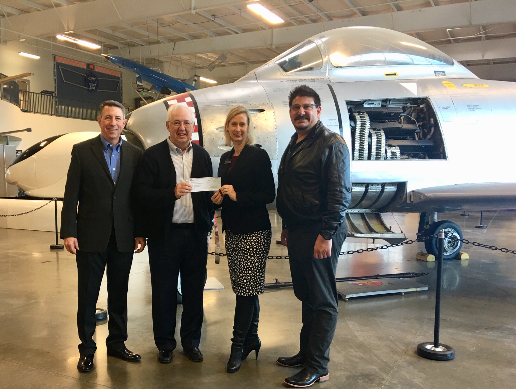 Aerospace Museum Executive Director Tom Jones, Aerospace Museum Board Chair Larry Miles, SAFE Credit Union AVP and Aerospace Board Member Melissa Bittman, and Sacramento County Board Supervisor Phil Serna pose with a $25,000 donation from SAFE to go toward the Aerospace Museum’s STEM education efforts.