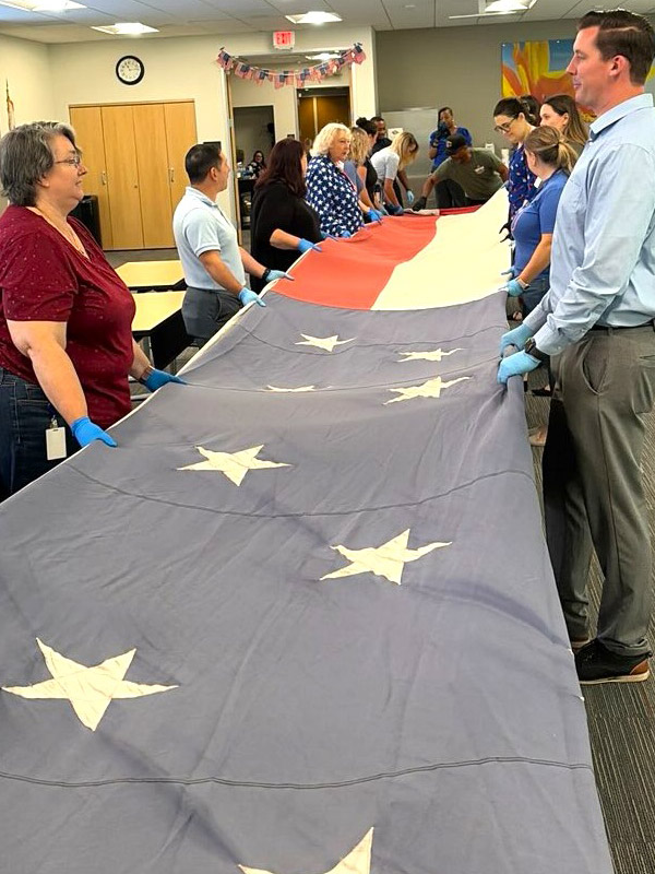 SAFE employees folding flags
