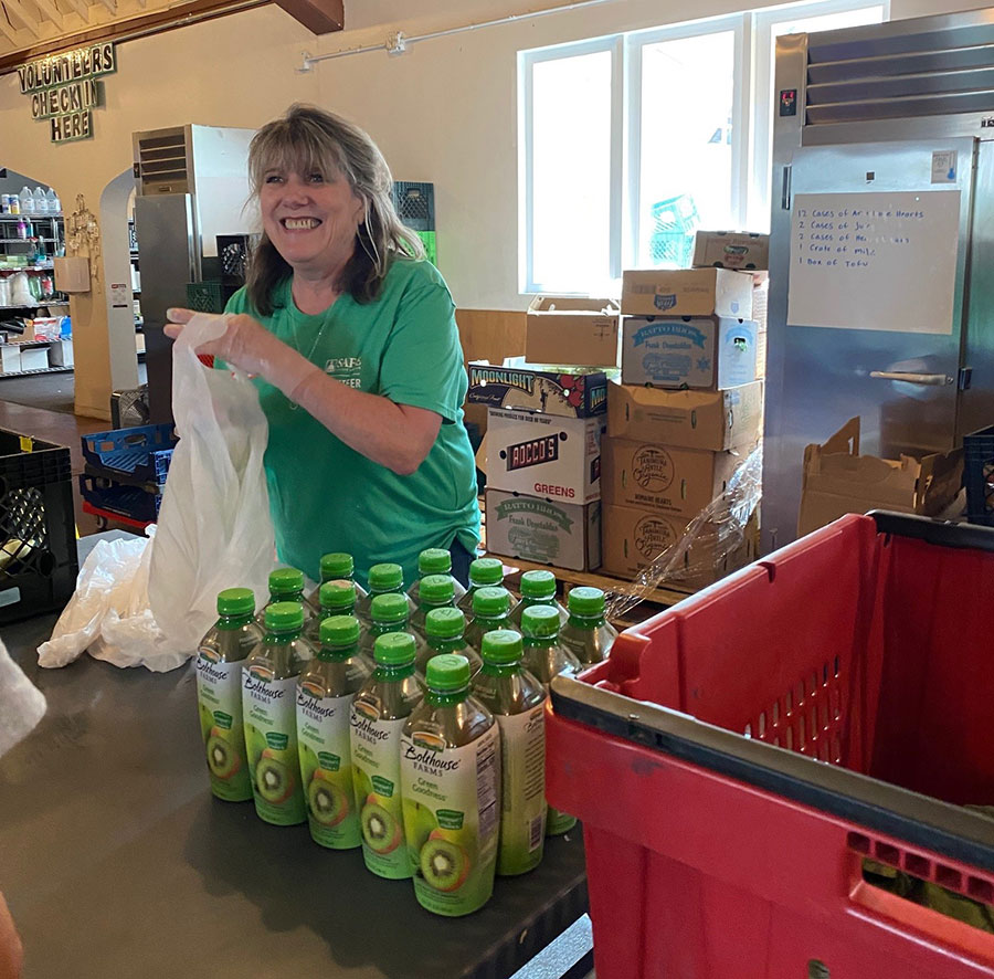 Karen Shahhoesseini hands out food at RiverCity Food Bank