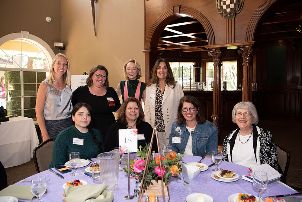 SAFE Community Impact Manager Amanda Merz (Fourth from Left, Back Row) joins fellow volunteers during a Women United event.