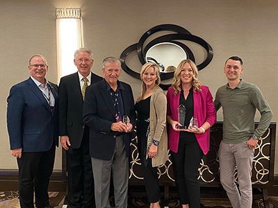 SAFE Board Director Ryan Larkin pose with advocacy and social impact awards