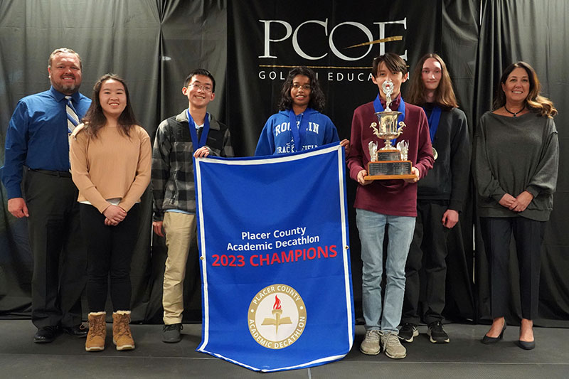 Members of the 2023 Placer County Academic Decathlon first-place team from Rocklin High School are recognized for their achievement with SAFE Credit Union Community Impact Manager Amanda Merz (Far right). Photo courtesy of the Placer County Office of Education.