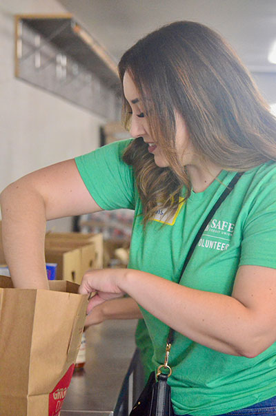 SAFE Credit Union Rancho Cordova Branch Manager Amaris Padill of Elk Grove packs groceries for Rancho Cordova Food Locker guests.