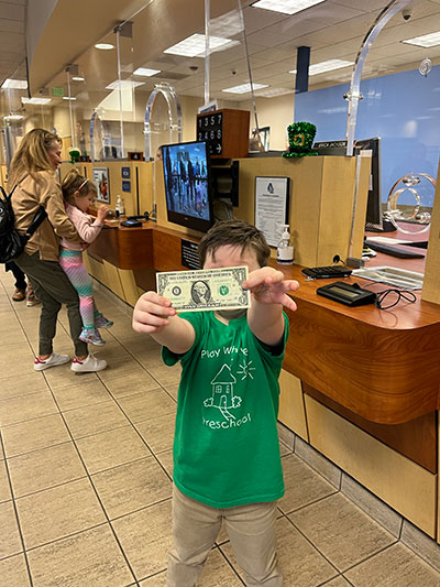 Preschooler Chadwick Weaver shows off his $1 withdrawal.