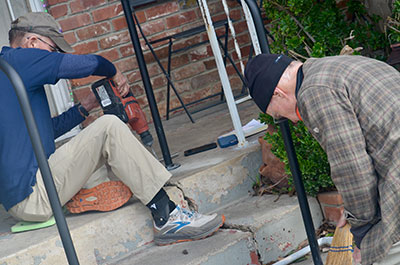 Safe at Home volunteers Dan Ward of Carmichael and Stan Jones of the
Greenhaven/Pocket area install a handrail for a Sacramento resident in need of safer access in and out of her
home.