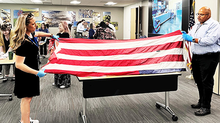 volunteers folding flag