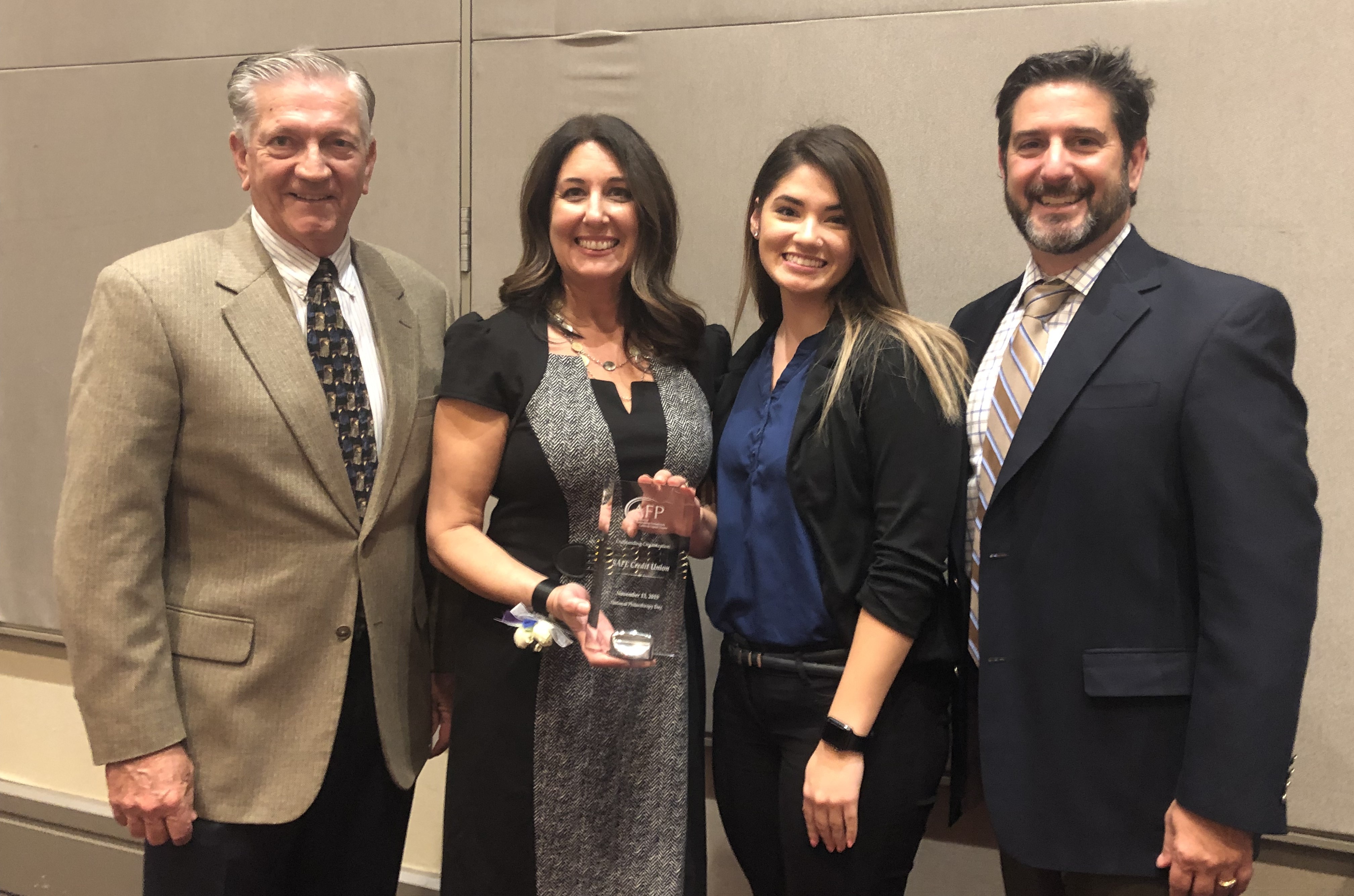 SAFE Board Chair Terrance Tremelling, Engagement Manager Amanda Merz, customer representative Britanny Dao, COO Jim Allen at awards ceremony.